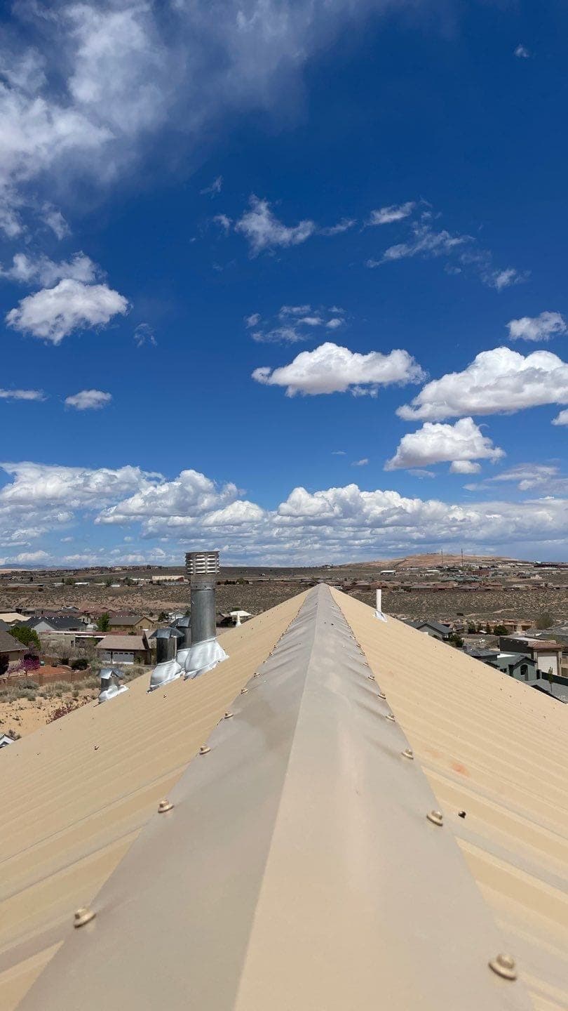 A finished tan metal roof on a New Mexico desert home by Paramount Roofing